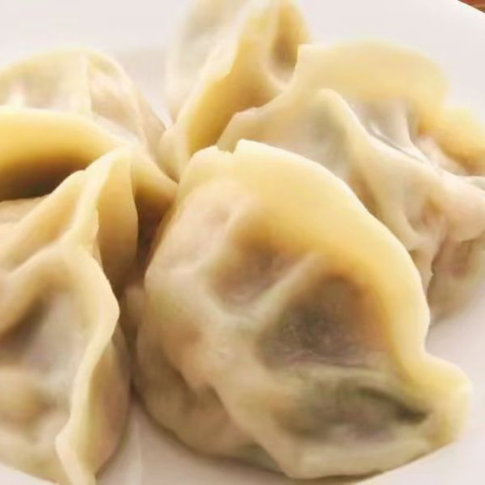 Steamed pork dumplings on a white plate at Taste of Xi'an, a Chinese Restaurant in Cromwell