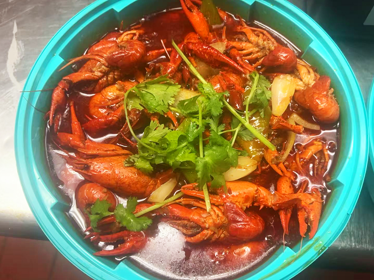 Bowl of spicy crayfish garnished with cilantro at Tasty Chinese Cuisine, a Chinese restaurant in Des Plaines