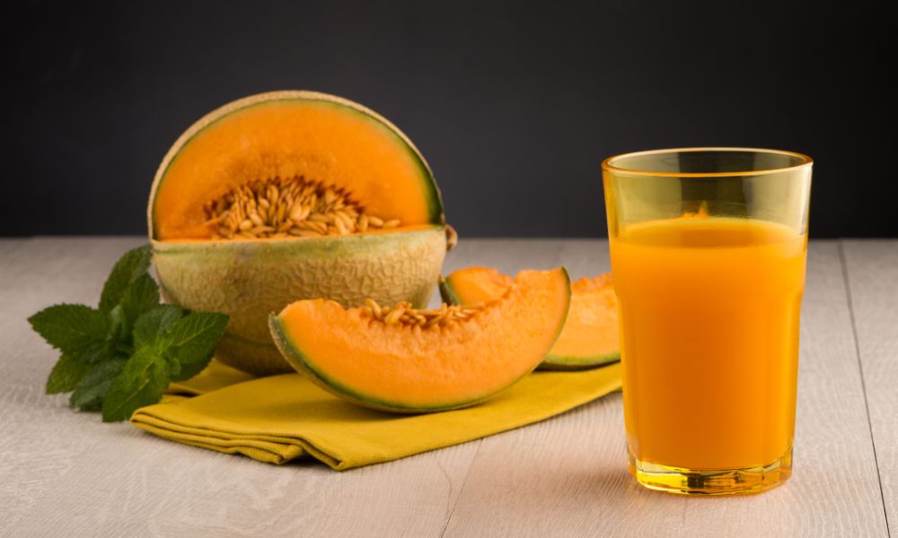 Fresh cantaloupe juice served with sliced melon and mint leaves at Tea & Brown - Yellowstone, a Bubble Tea Store in West Yellowstone