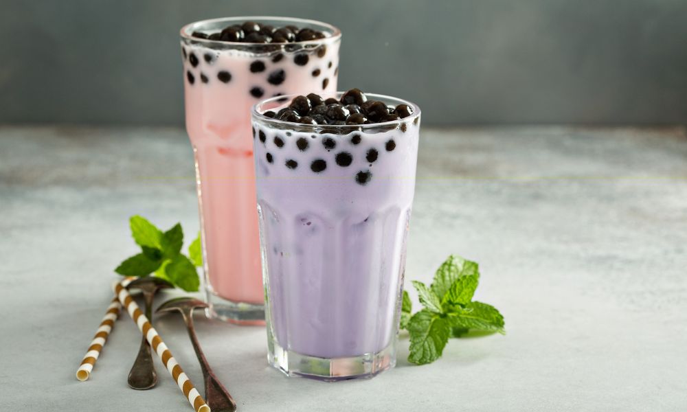 Pink and taro bubble teas with tapioca pearls in tall glasses at Tea & Brown - Yellowstone, a Bubble Tea Store in West Yellowstone