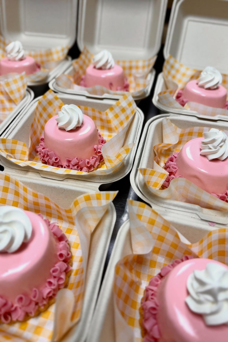 Glossy pink mousse mini cakes in takeout boxes at Tea.Lab, a Bubble Tea Store in FL