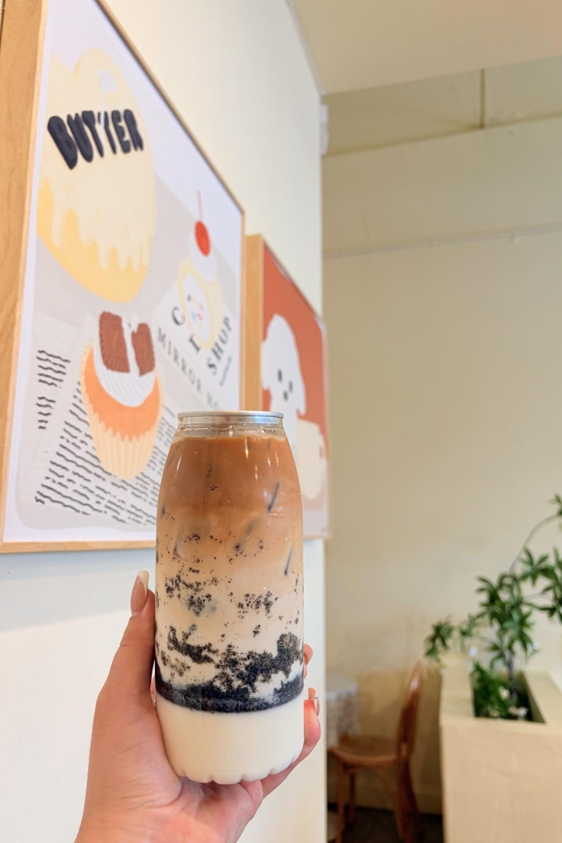 Layered black sesame latte milk tea in glass bottle at Tea.Lab, a Bubble Tea Store in FL