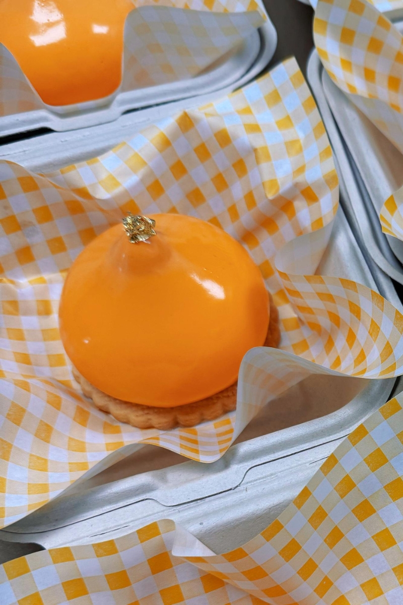 Shiny orange mousse tart with gold foil decoration at Tea.Lab, a Bubble Tea Store in FL