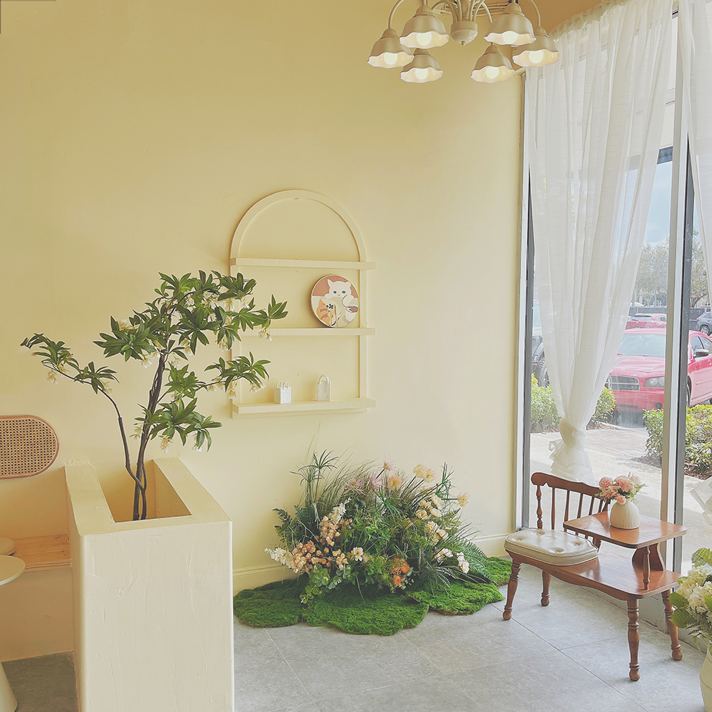 Soft cream-toned cafe interior with floral decor at Tea.Lab, a Bubble Tea Store in FL