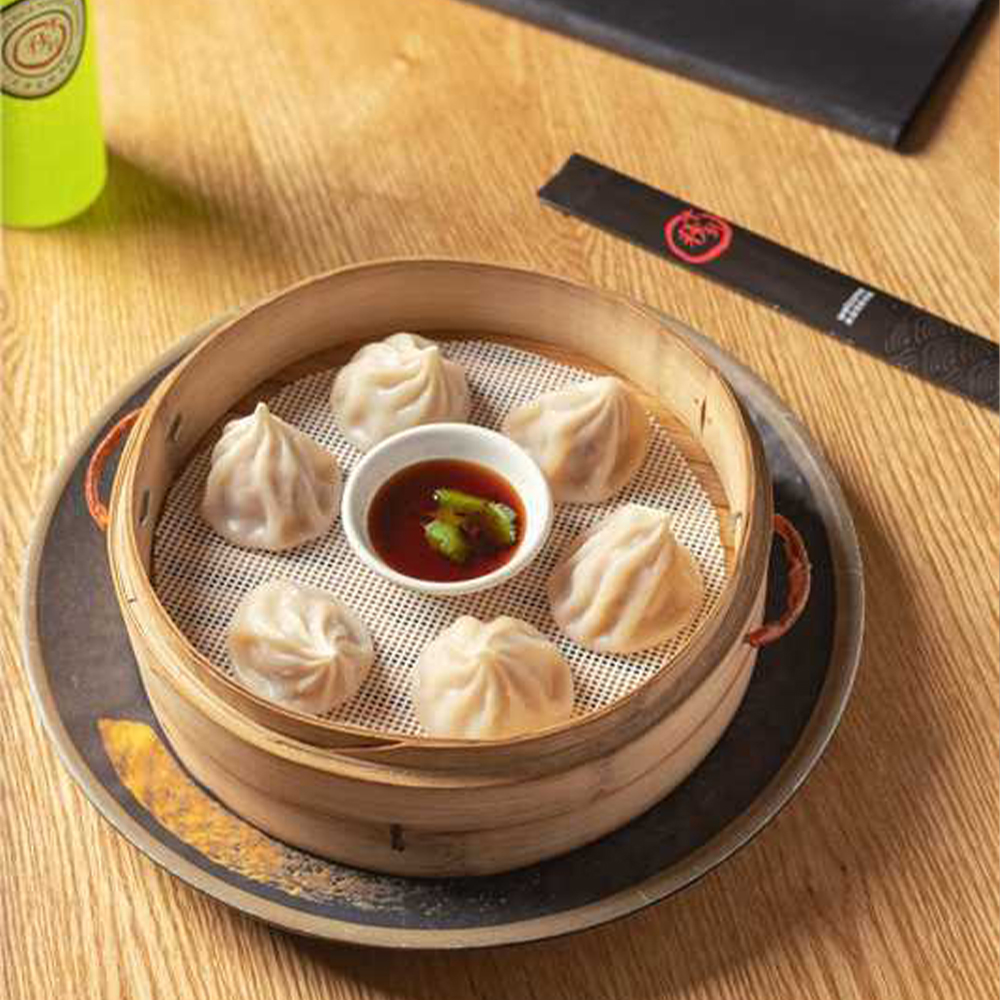 Juicy pork buns with dipping sauce at Ten Seconds Rice Noodle & Ramen, a Asian Restaurant in Jacksonville
