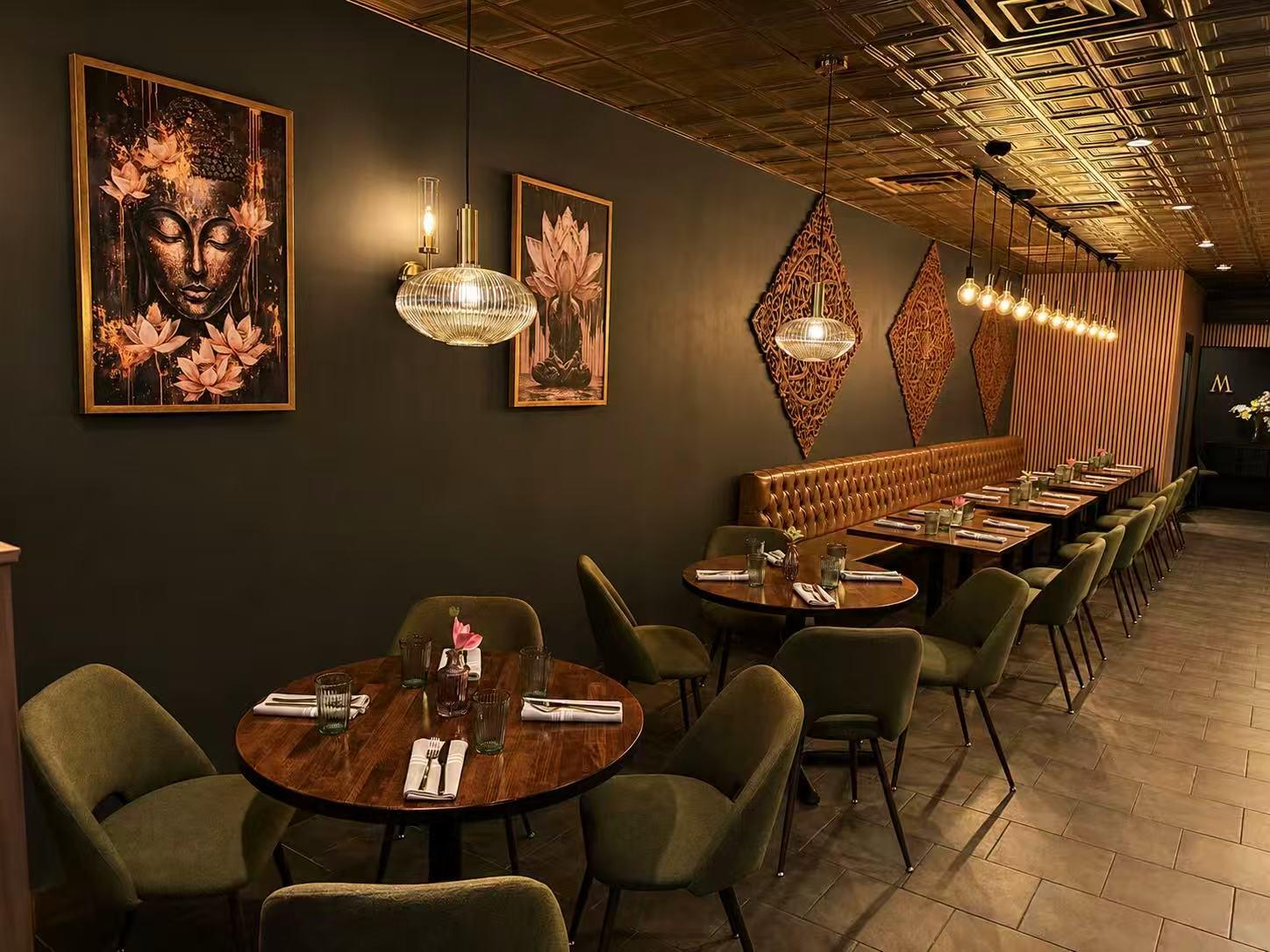 Elegant Thai Restaurant Interior with Warm Lighting and Lotus Wall Art