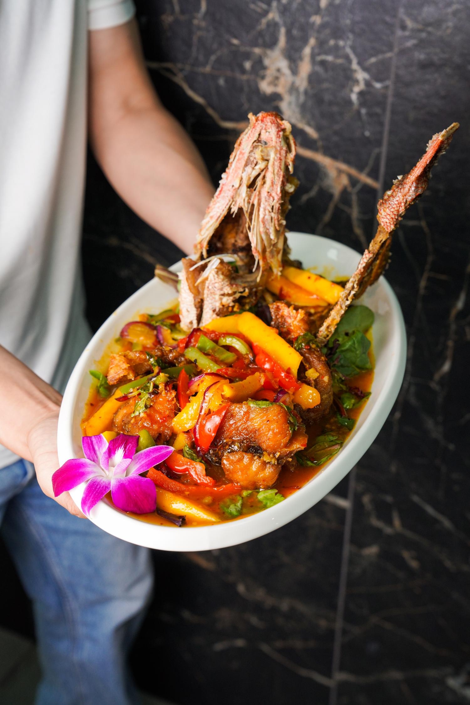 Stir-fried whole red snapper with mango, chili and aromatic herbs