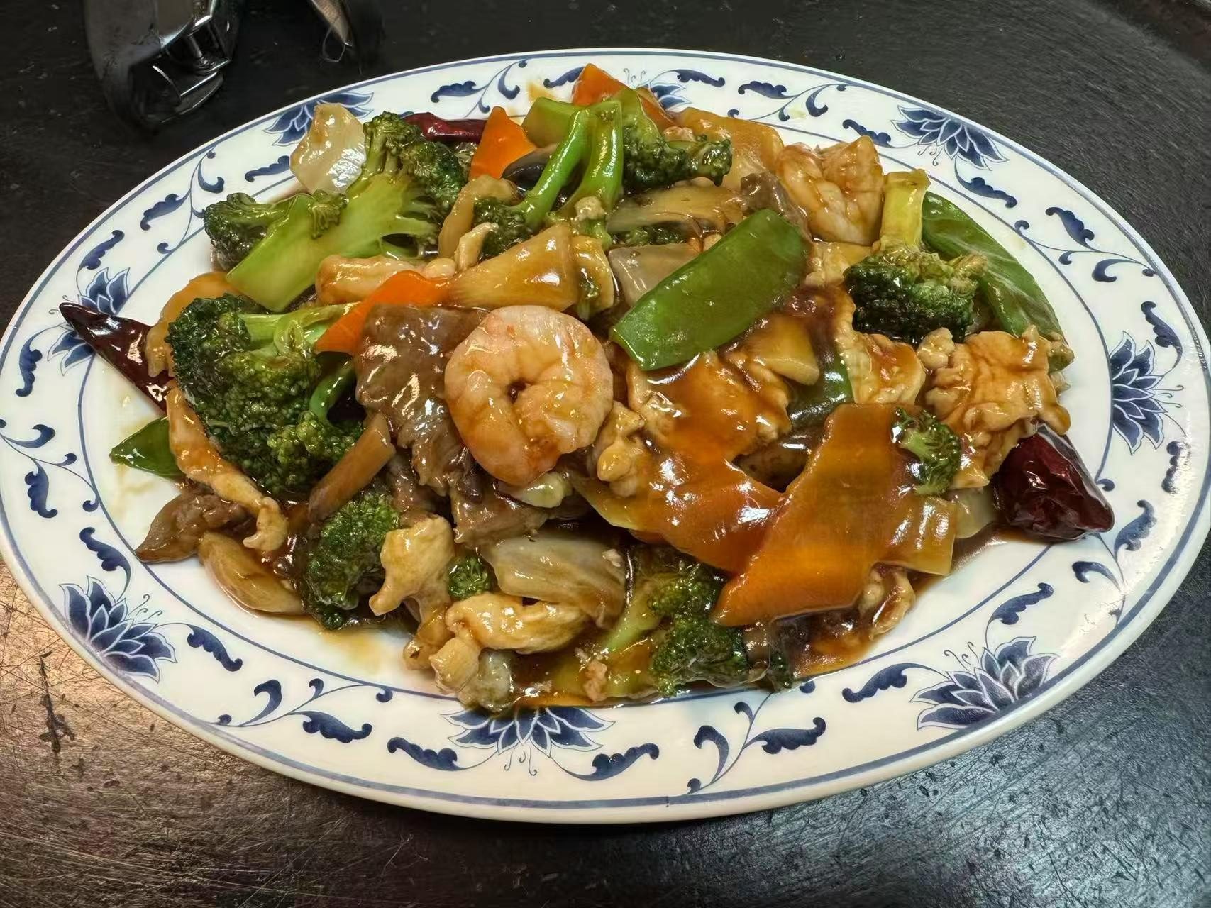 Stir - fried shrimp, veggies, and meat in savory sauce at The Great Wall, a Chinese restaurant in Seguin