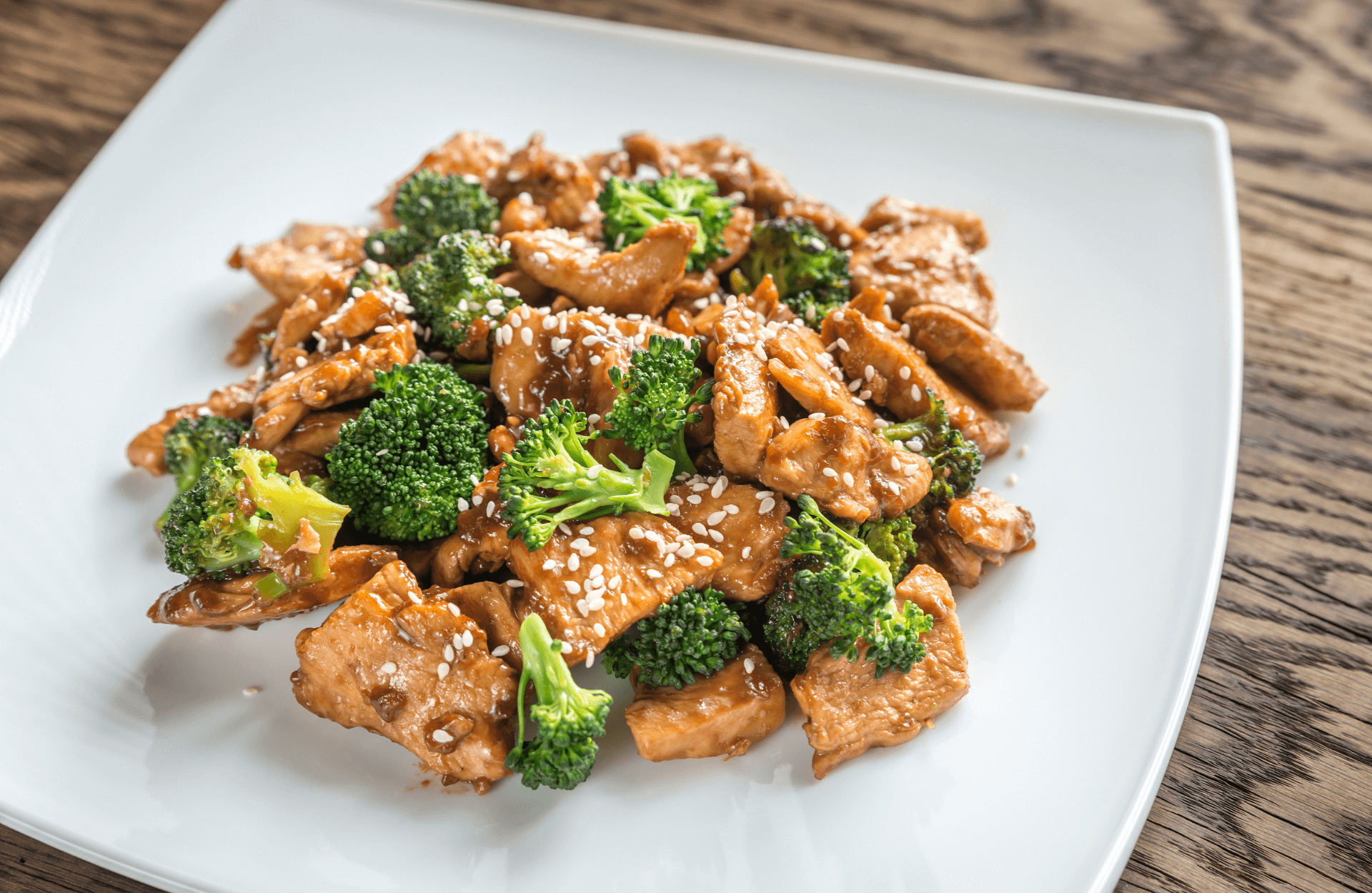 Tender chicken stir - fried with fresh kailan in savory sauce at The Great Wall, a Chinese restaurant in Seguin