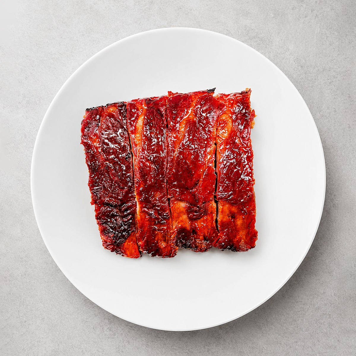 Glazed Chinese barbecue pork sliced on a white plate at The Jade Bowl House, a Chinese Restaurant in Columbus