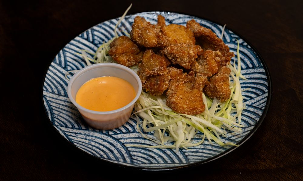 Crispy fried chicken bites with tangy sauce at The Noodle Smith, a Asian Restaurant in Cary