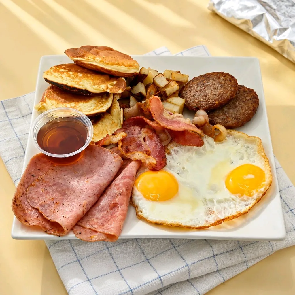 Full breakfast platter with eggs, ham, bacon, patties and pancakes at The Second Wind, a Breakfast Restaurant in El Segundo