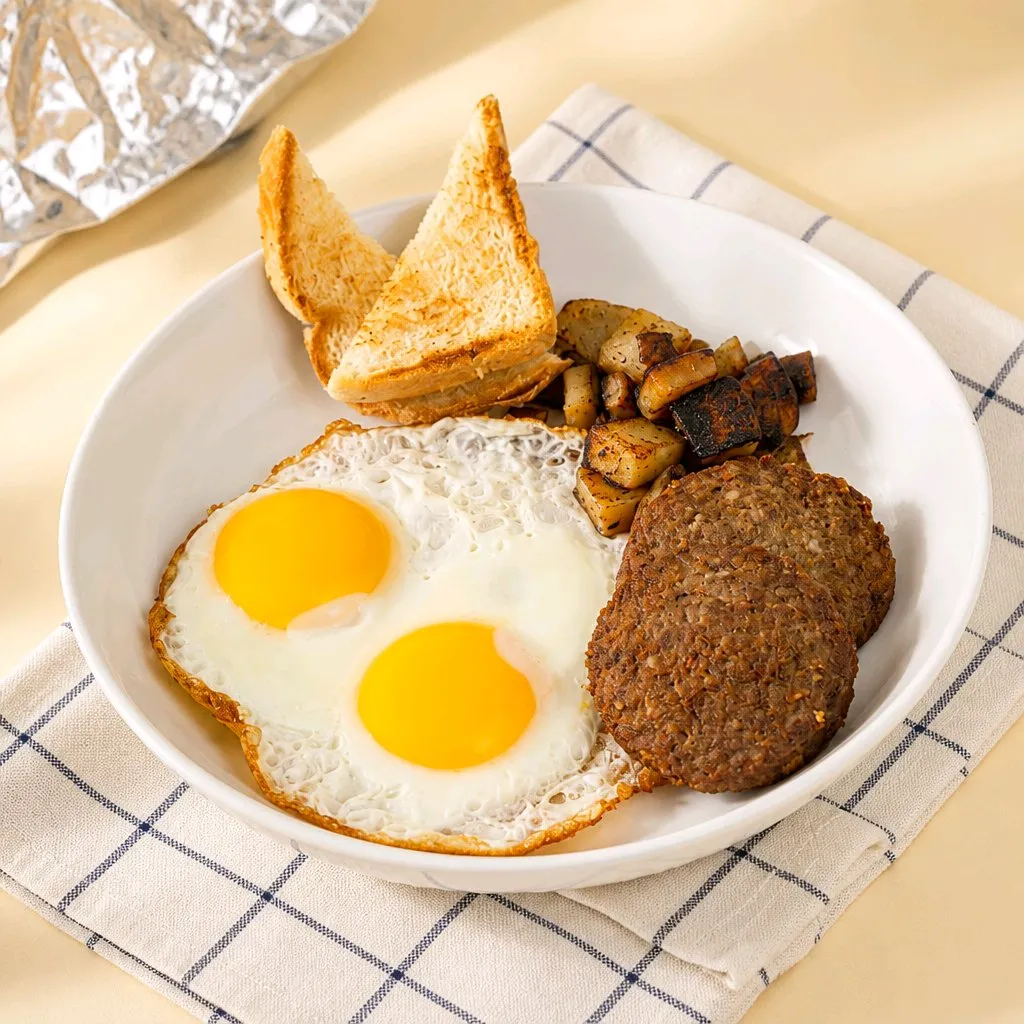 Two fried eggs, beef patties, toast and roasted potato cubes at The Second Wind, a Breakfast Restaurant in El Segundo