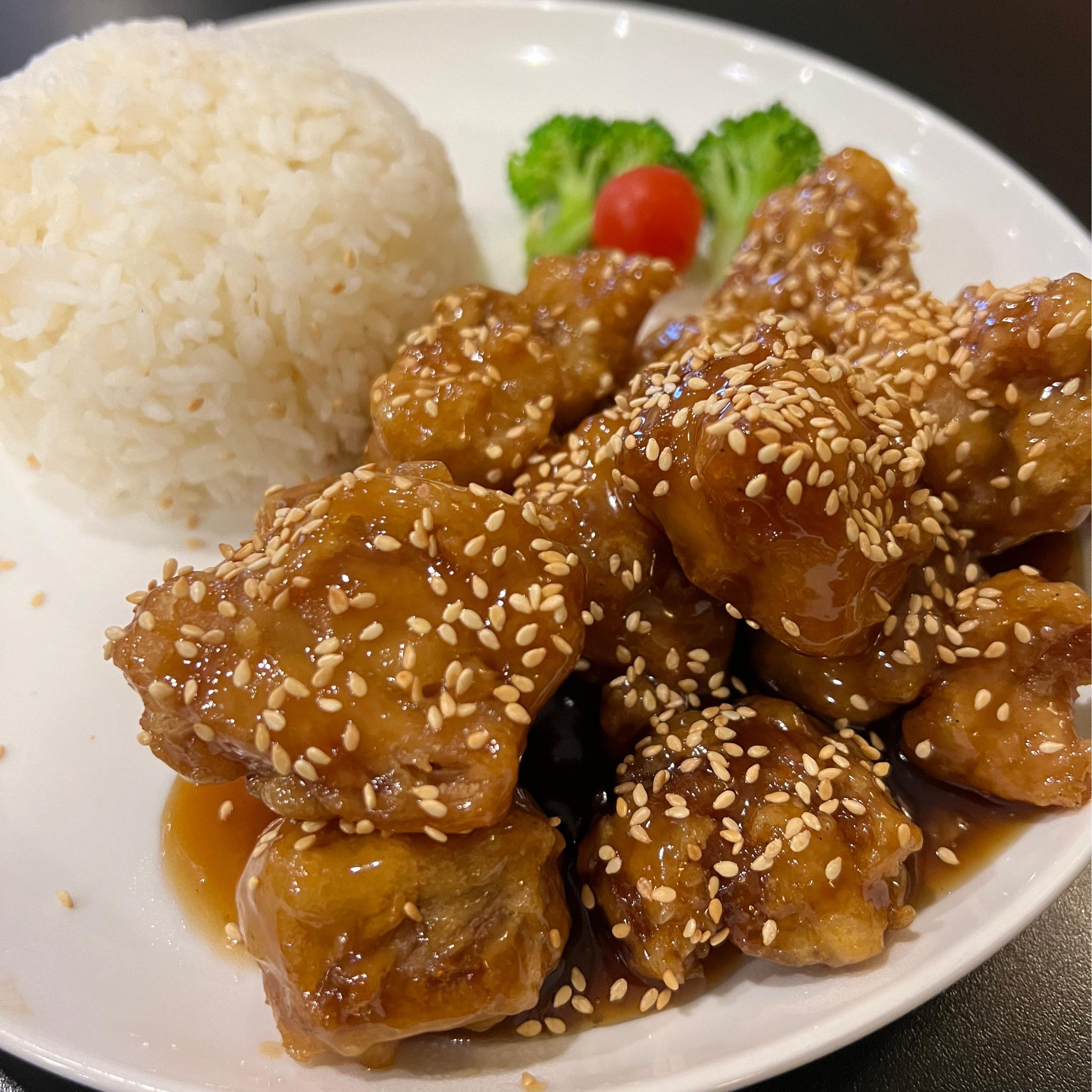 Sesame Chicken Rice Plate - Crispy chicken in sweet sauce, sprinkled with sesame, with rice at Tiger's Chinese Cuisine, a Chinese Restaurant in Houston