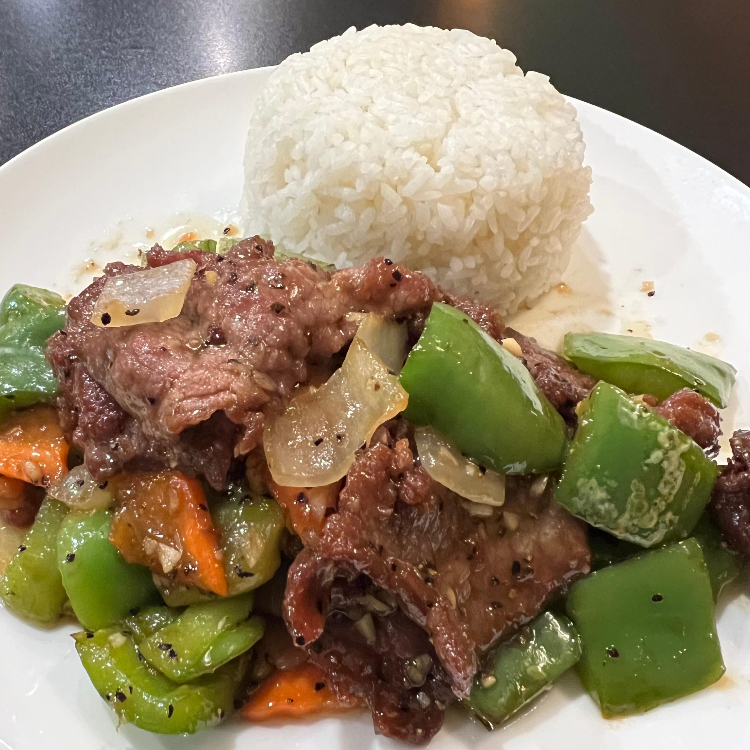 Black Pepper Beef Rice Plate - Tender beef with green peppers, onions, served with white rice at Tiger's Chinese Cuisine, a Chinese Restaurant in Houston