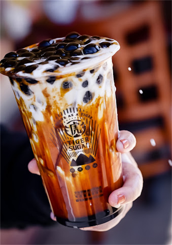 Close-up of brown sugar tiger stripe bubble tea cup filled with black tapioca pearls at Tiger Sugar, a Bubble tea store in Philadelphia