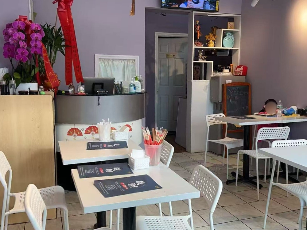 Cozy dining area with white tables, chairs, and Taiwanese decor at Ti Hu Taiwanese Noodle House, a Chinese Restaurant in Bayside