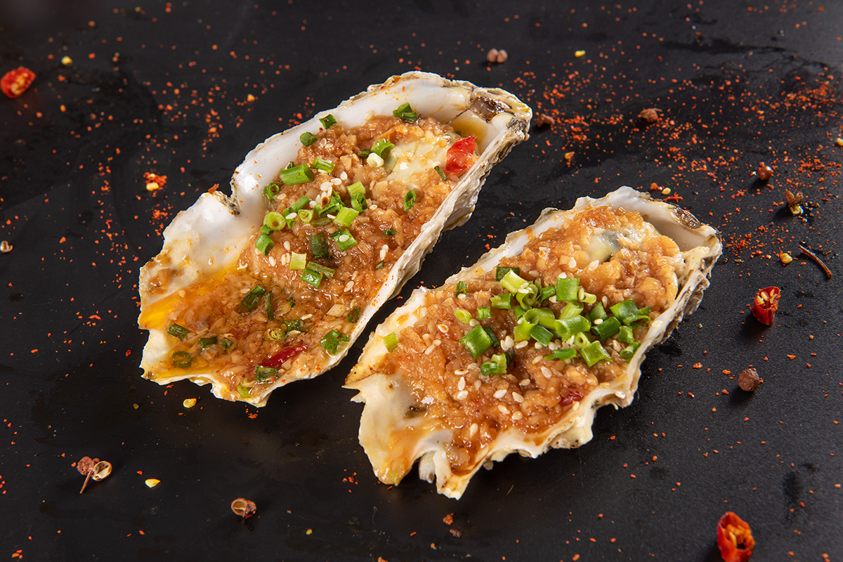 Grilled fresh oyster with spices at Tipsy Nine，a Asian Fusion Restaurant in Houston