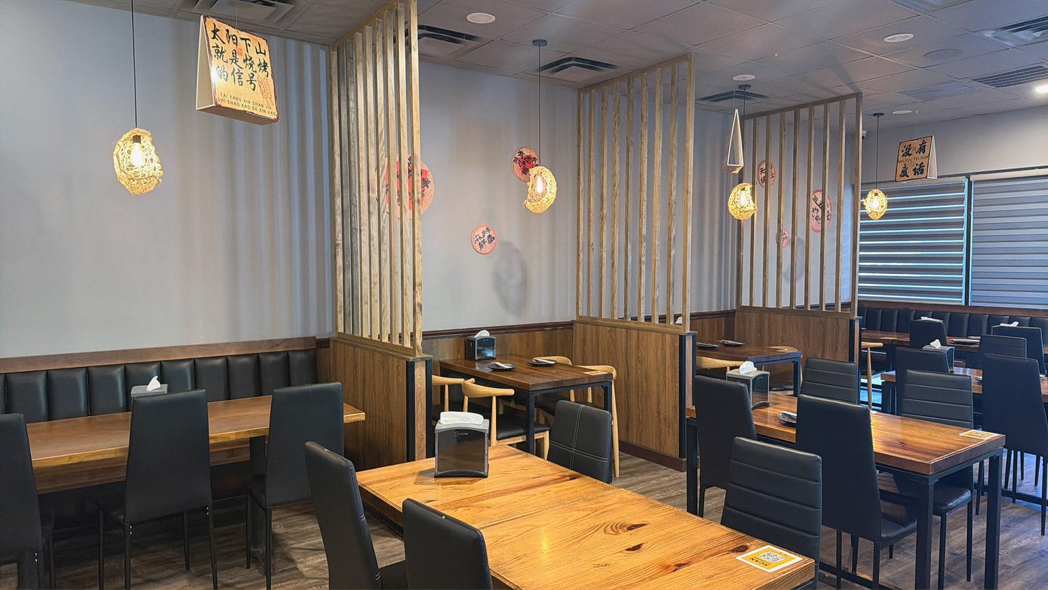 wooden partitions, warm pendant lights, and dining tables at Tipsy Nine，a Asian Fusion Restaurant in Houston