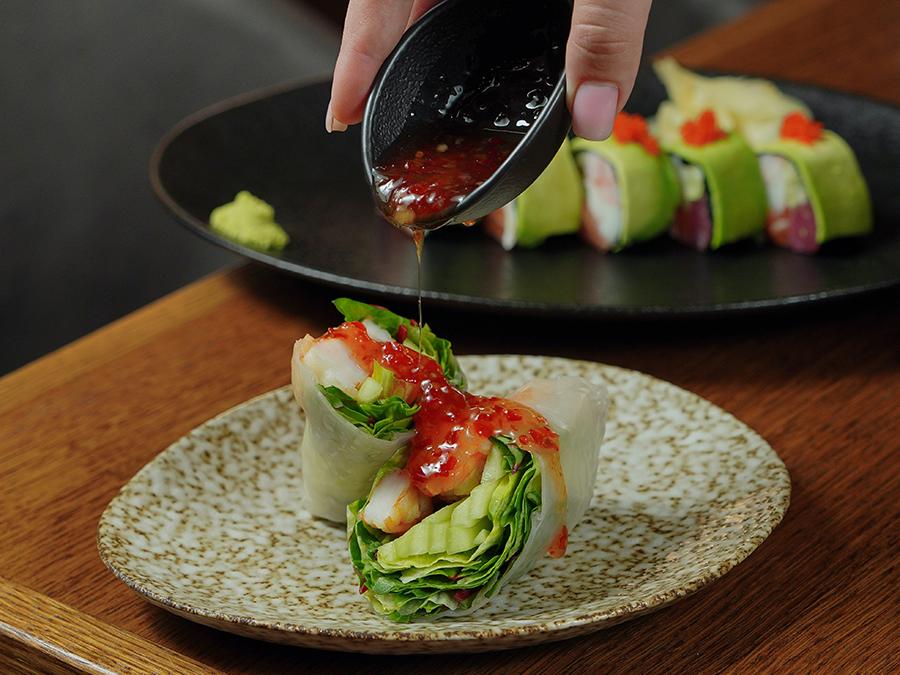 Fresh spring rolls with shrimp and veggies, drizzled with sauce at Tokyo Cafe Sushi and Asian Food, a Asian Fusion Restaurant in Lubbock