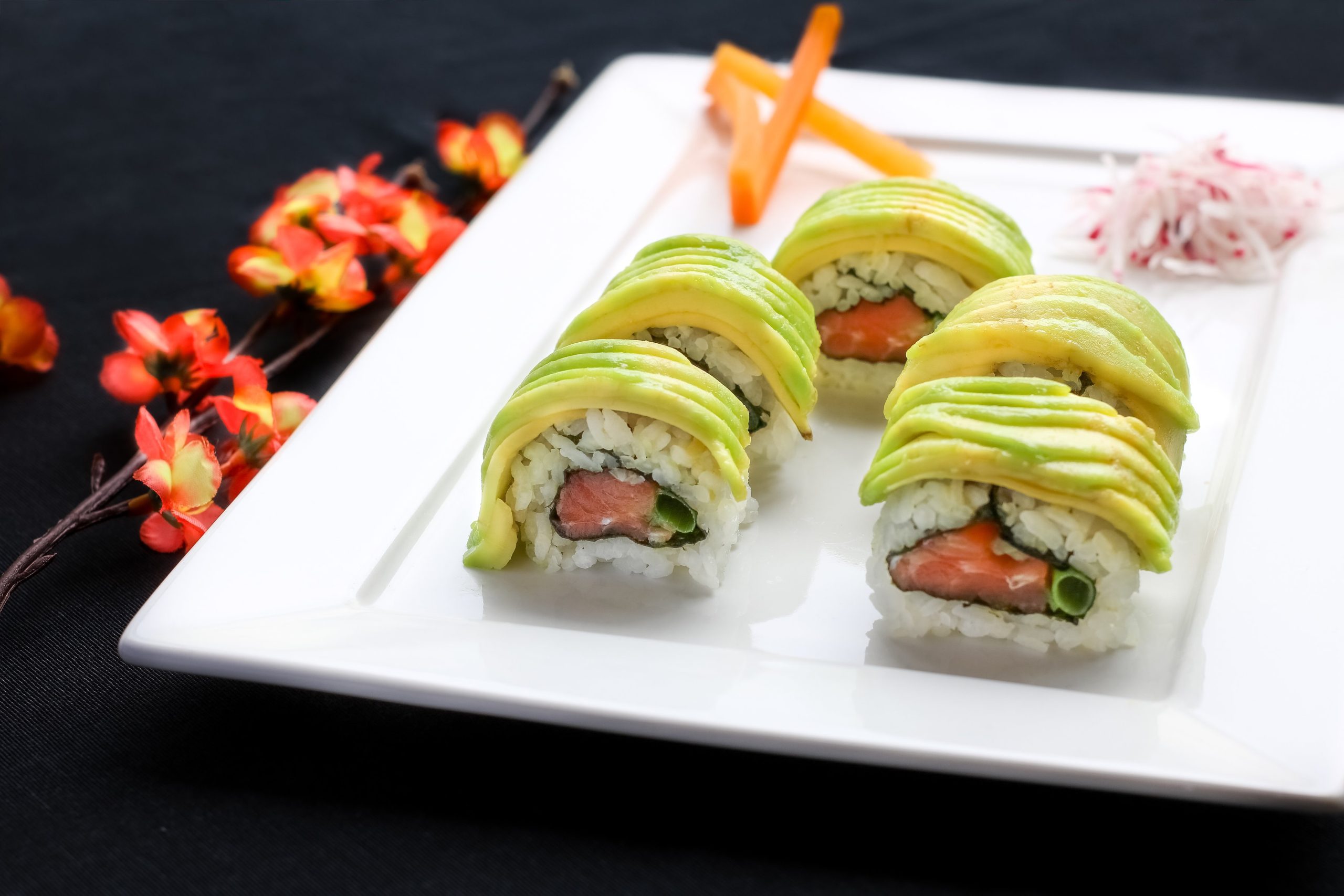Sushi roll with salmon and avocado slices, elegantly plated at Tokyo Cafe Sushi and Asian Food, a Asian Fusion Restaurant in Lubbock