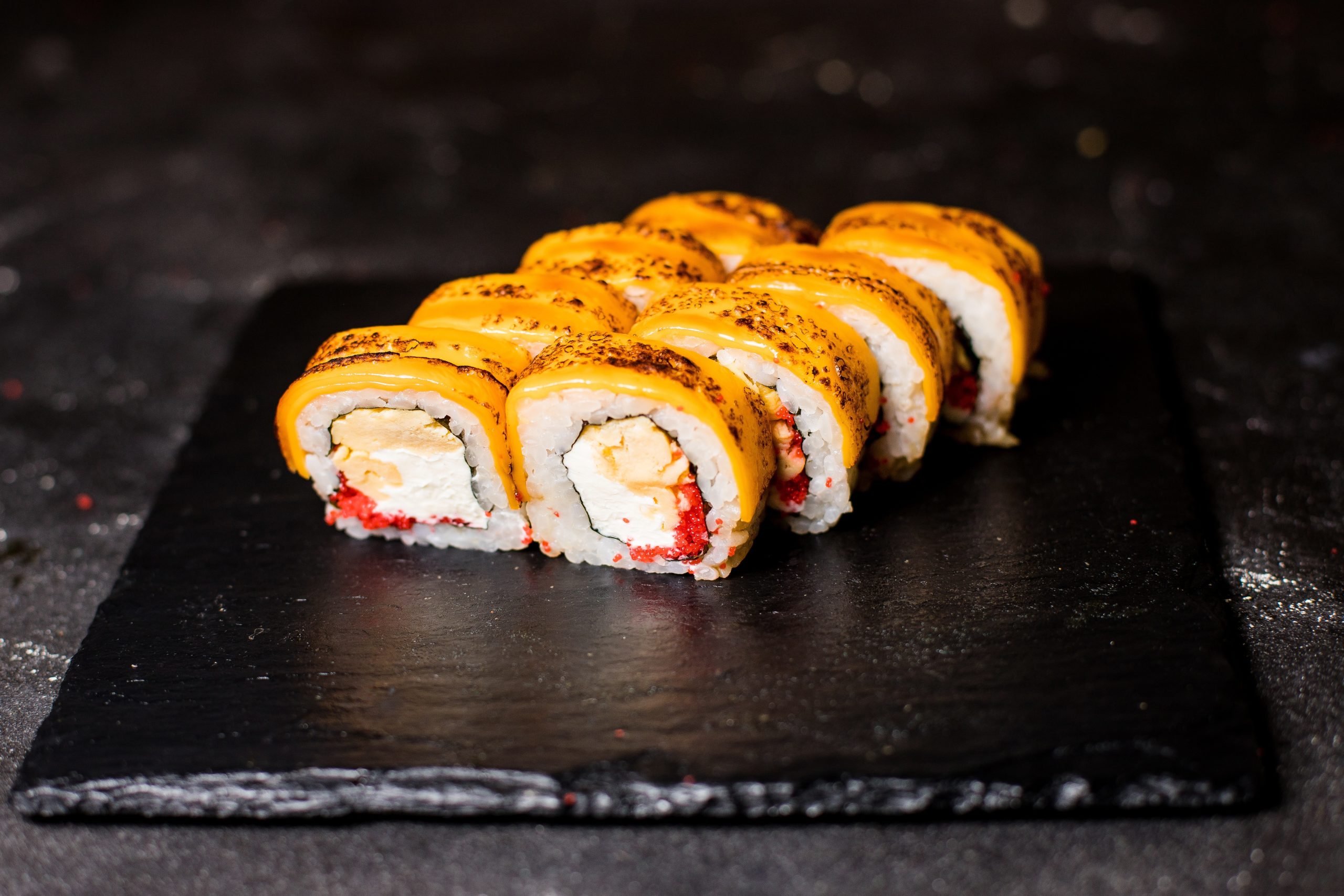 Specialty sushi roll with orange topping and creamy filling at Tokyo Cafe Sushi and Asian Food, a Asian Fusion Restaurant in Lubbock