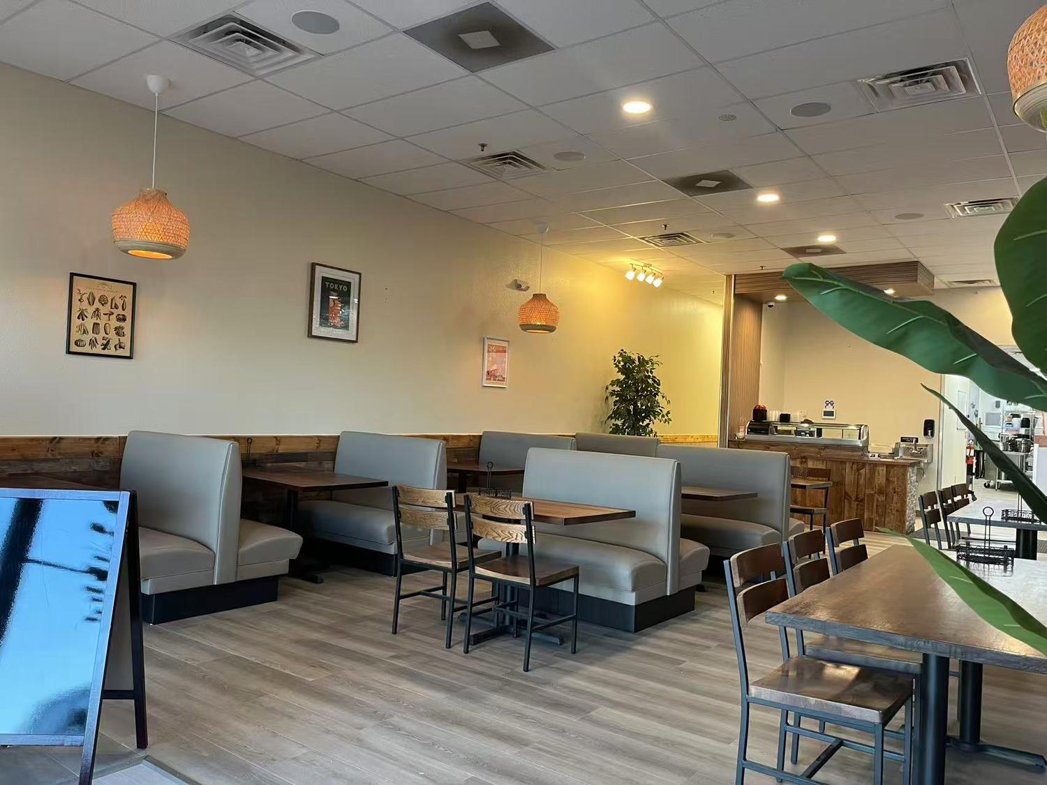 Warm dining area with wooden decor, booths and wall art at Tokyo Cafe Sushi and Asian Food, a Asian Fusion Restaurant in Lubbock