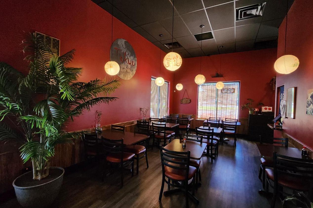 Dining Area - Cozy dining space with red walls, plants & hanging lanterns at Tokyo Japanese Restaurant in Twin Falls