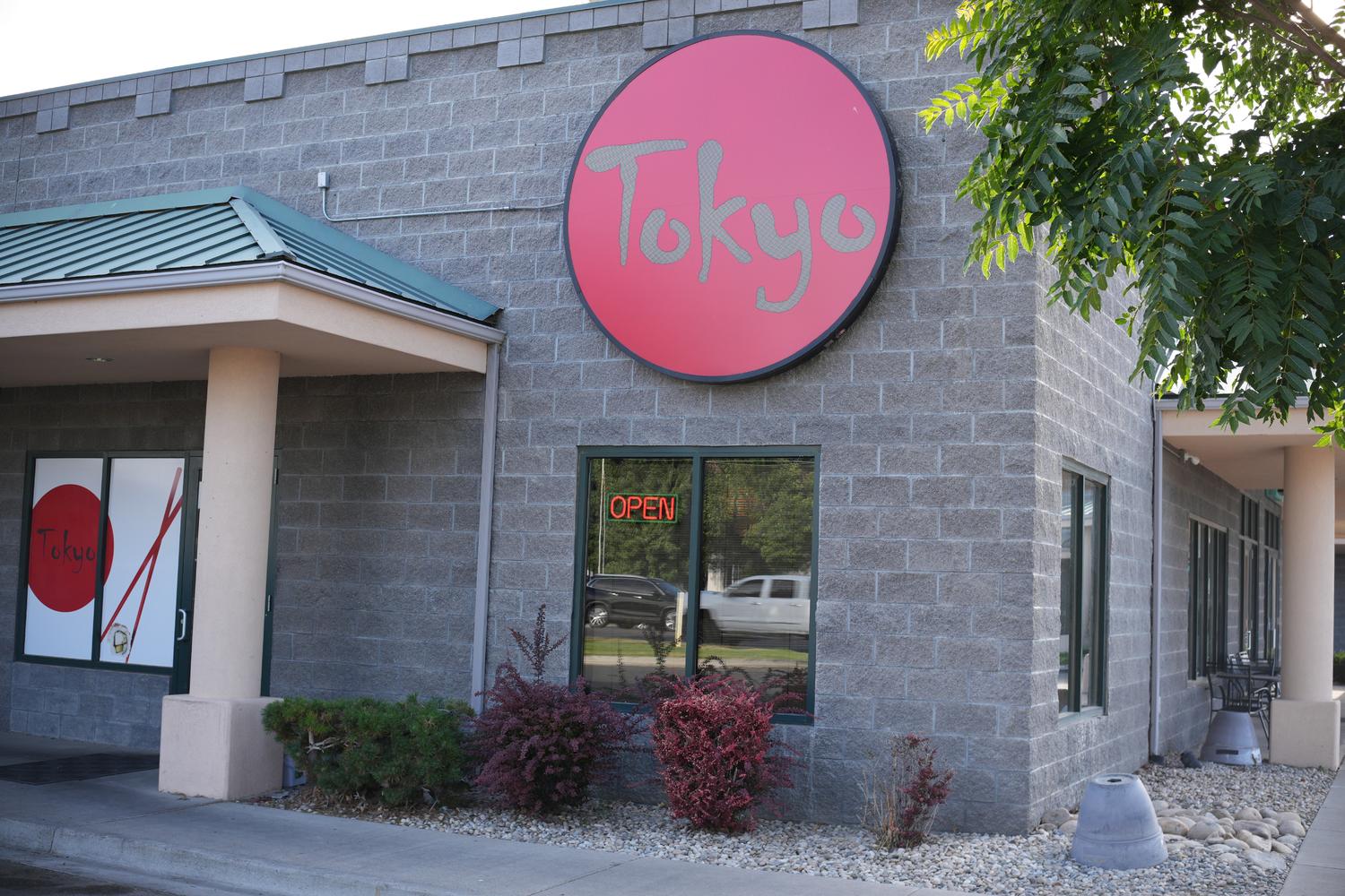 Interior Sign - Circular metal sign with “Tokyo” in red letters at Tokyo Japanese Restaurant in Twin Falls