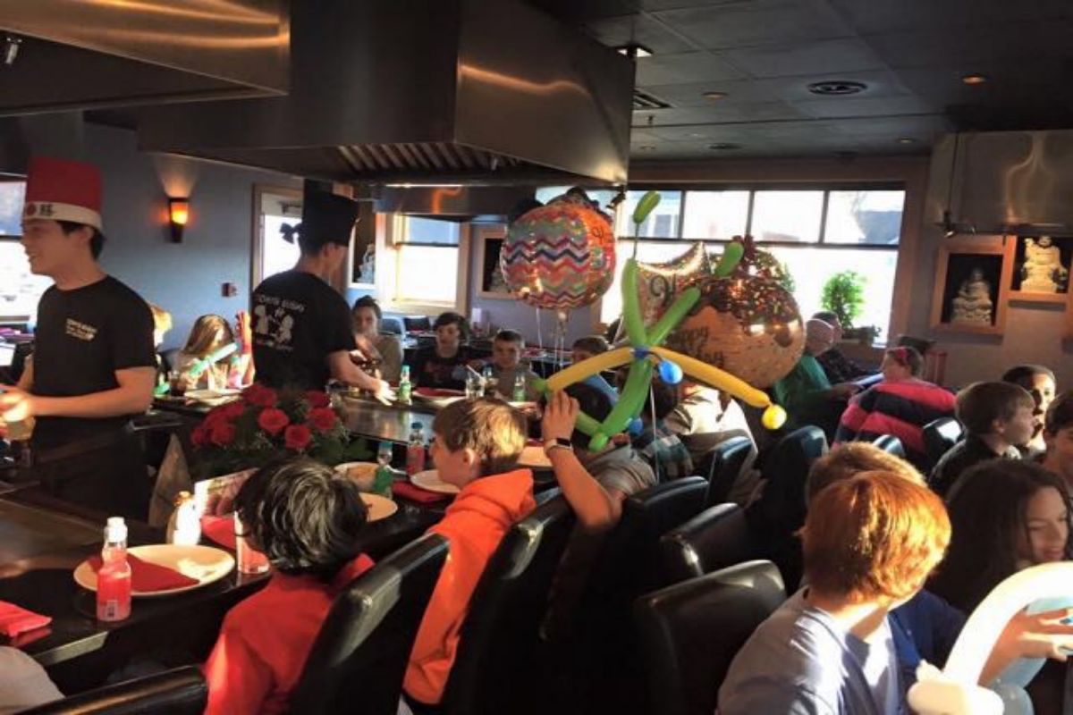 Birthday teppanyaki table with chefs and party balloons at Tony's Sushi & Steakhouse, a Japanese Restaurant in East Moriches