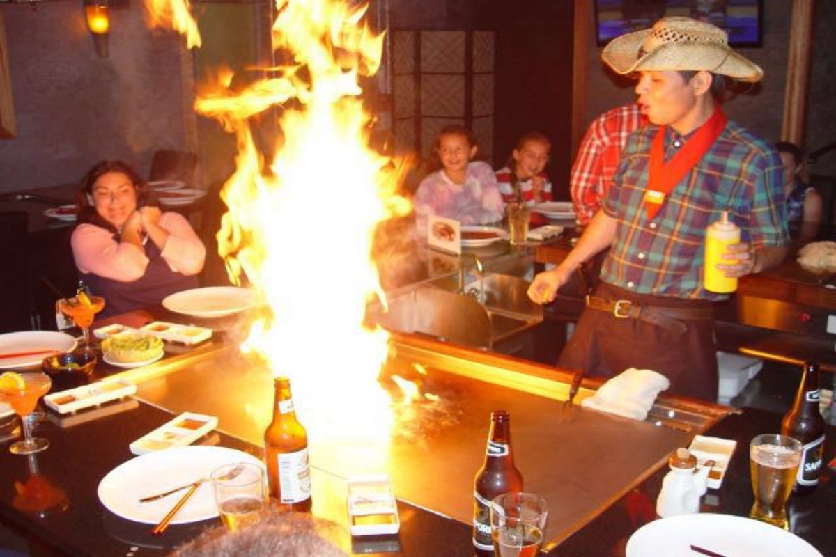 Chef creates dramatic fire show on teppanyaki grill at Tony's Sushi & Steakhouse, a Japanese Restaurant in East Moriches