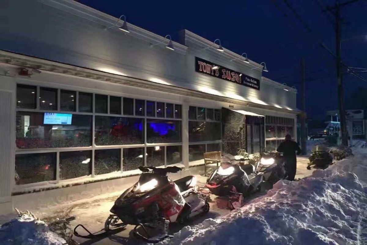 Exterior view of restaurant with snowmobiles parked outside at Tony's Sushi & Steakhouse, a Japanese Restaurant in East Moriches