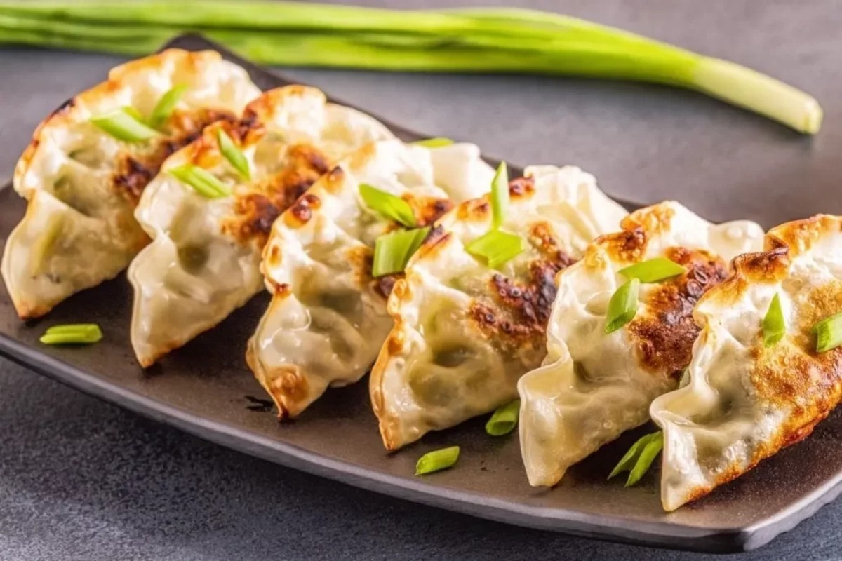 Pan-fried gyoza dumplings topped with chopped green onions at Tony's Sushi & Steakhouse, a Japanese Restaurant in East Moriches