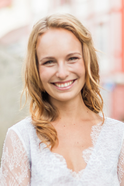 Portrait of Michelle, identified as a food critic, with a friendly smile