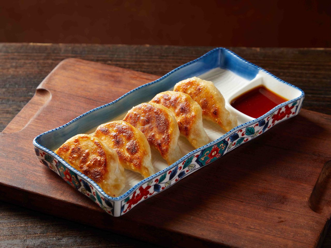 Crispy homemade pan-fried gyoza with dipping sauce at Tosakko Ramen & Yakitori, a Japanese Restaurant in Pasadena