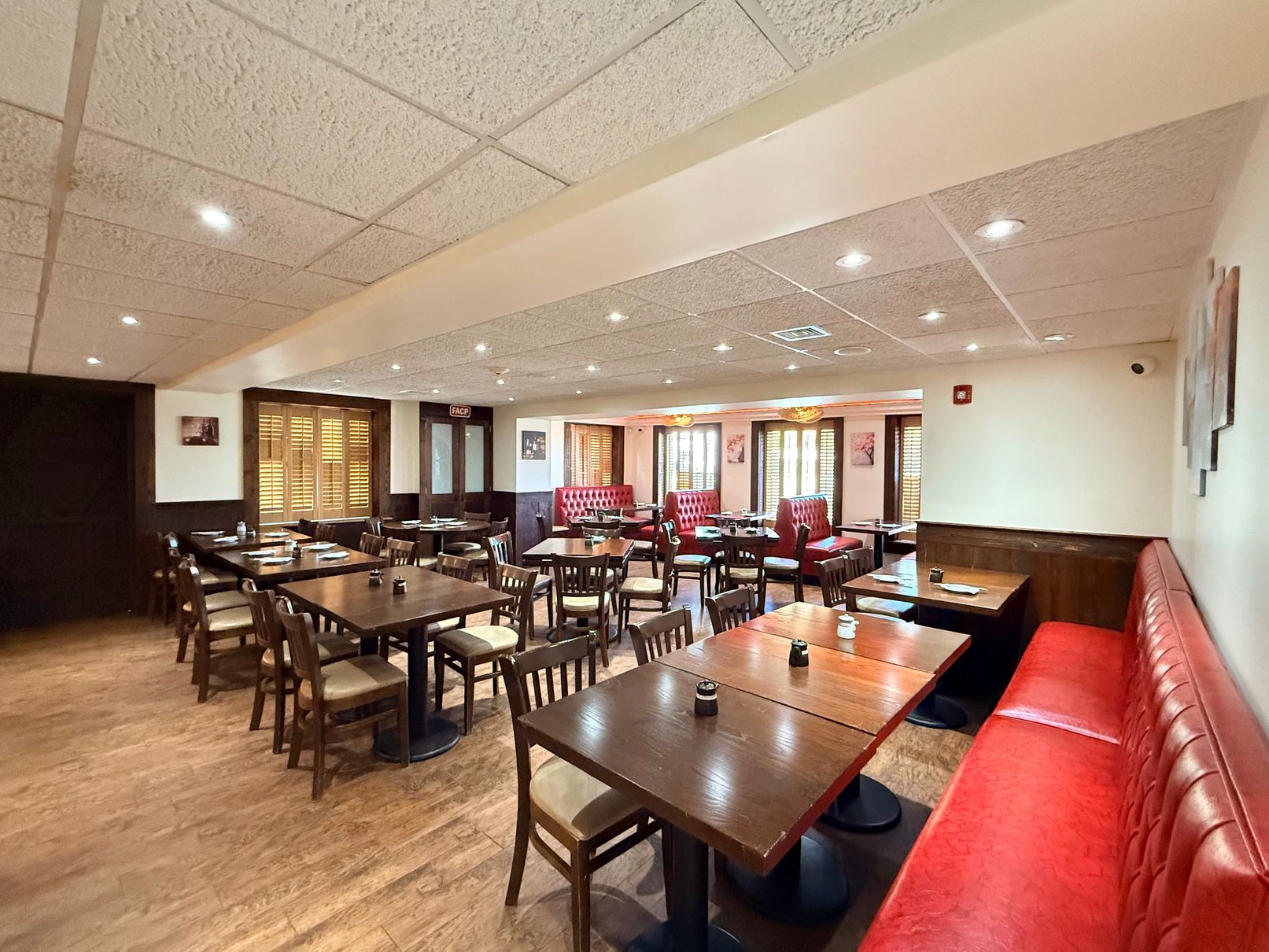 Dining area with red booths at Tsukiyo Sushi Restaurant, a Sushi Restaurant in Smithtown