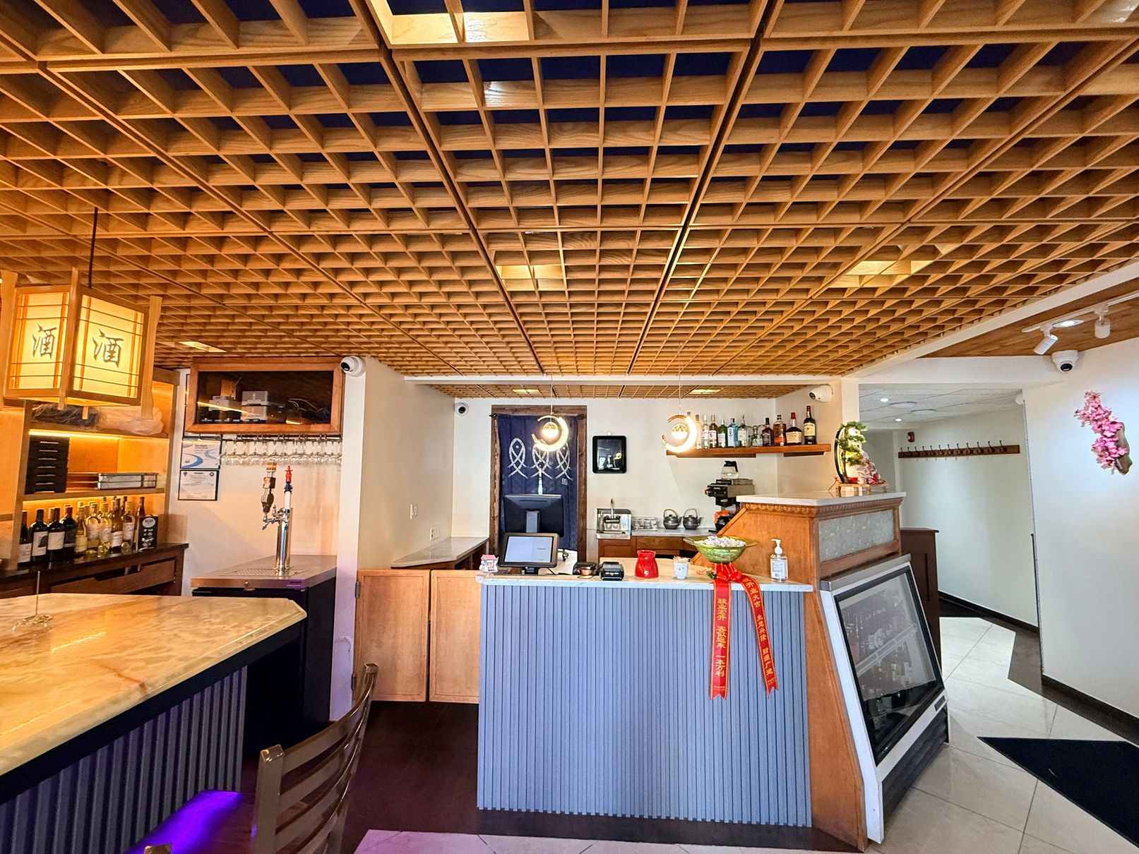 Bar area with wooden lattice ceiling at Tsukiyo Sushi Restaurant, a Sushi Restaurant in Smithtown