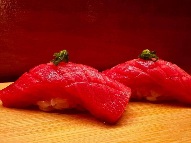 Fresh toro sushi with vibrant red tuna and garnish at Tsukiyo Sushi Restaurant, a Sushi Restaurant in Smithtown