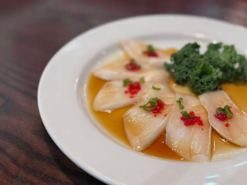 White tuna slices with truffle sauce and garnish at Tsukiyo Sushi Restaurant, a Sushi Restaurant in Smithtown