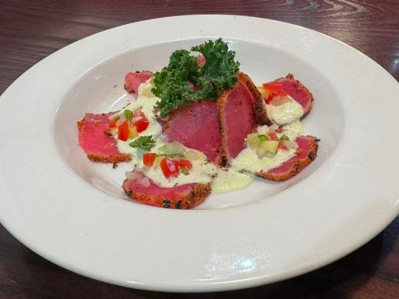 Pepper-crusted tuna slices with sauce and veggies at Tsukiyo Sushi Restaurant, a Sushi Restaurant in Smithtown