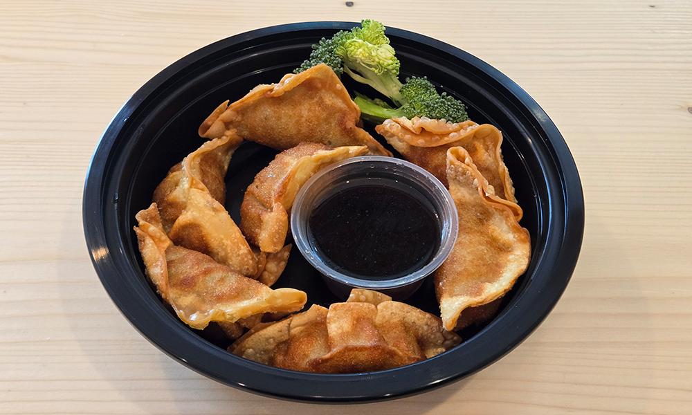 Golden pan-fried dumplings with soy dipping sauce at U Bowl, a Asian Restaurant in Winston-Salem