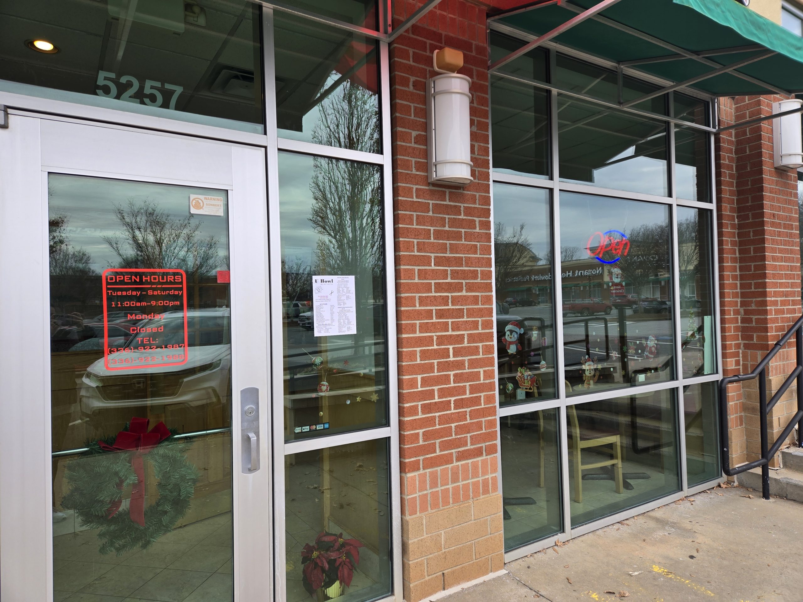 Brick-front entrance with open hours displayed at U Bowl, a Asian Restaurant in Winston-Salem