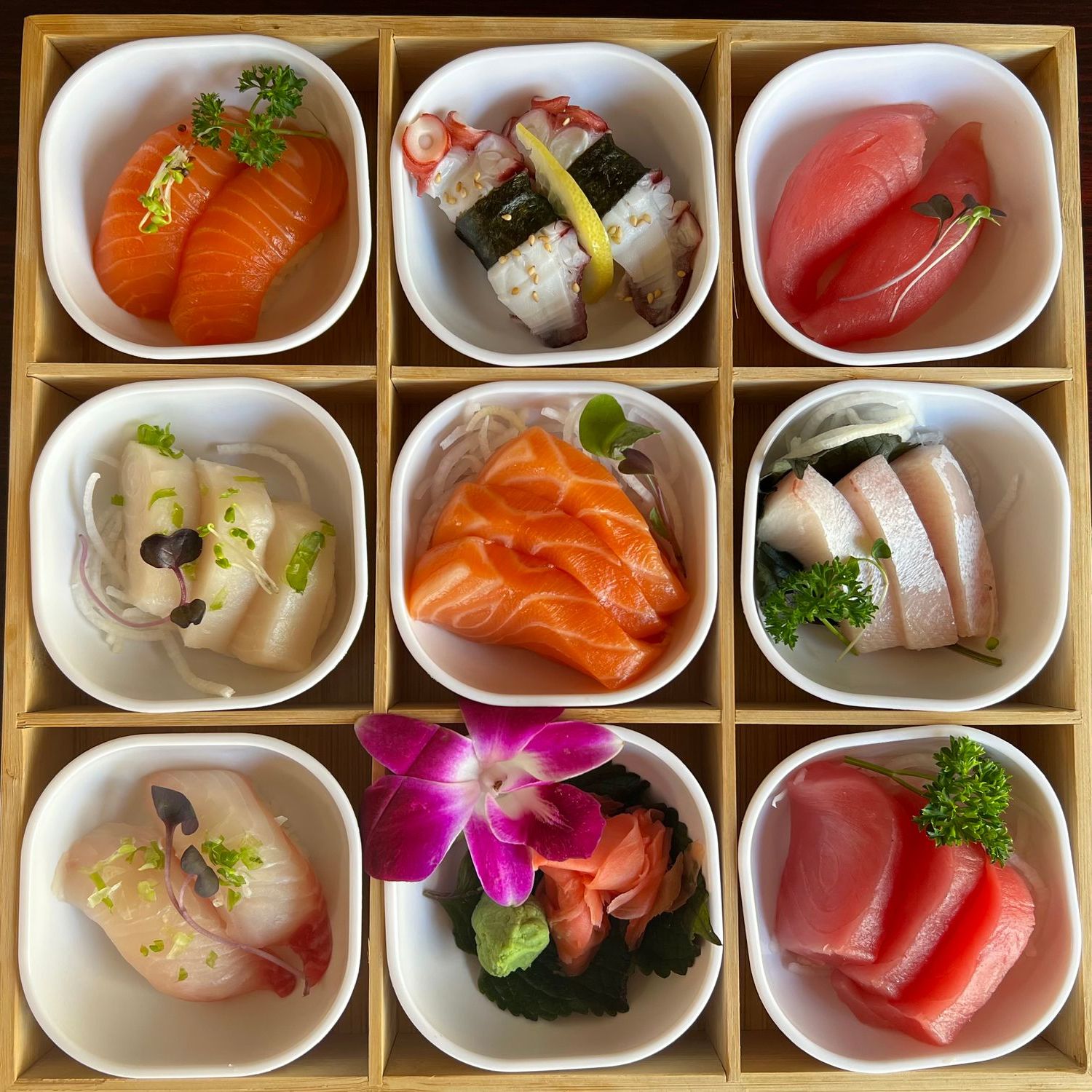 9-section wooden bento box filled with assorted nigiri and sashimi varieties at Umami Sushi & Chinese Cuisine, an Asian Fusion Restaurant in Minneapolis