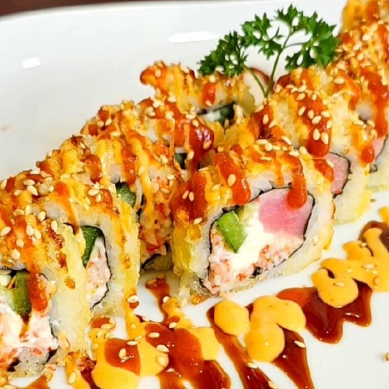 Crunchy tempura tuna sushi roll drizzled with sauces at Umami Sushi & Chinese Cuisine, an Asian Fusion Restaurant in Minneapolis
