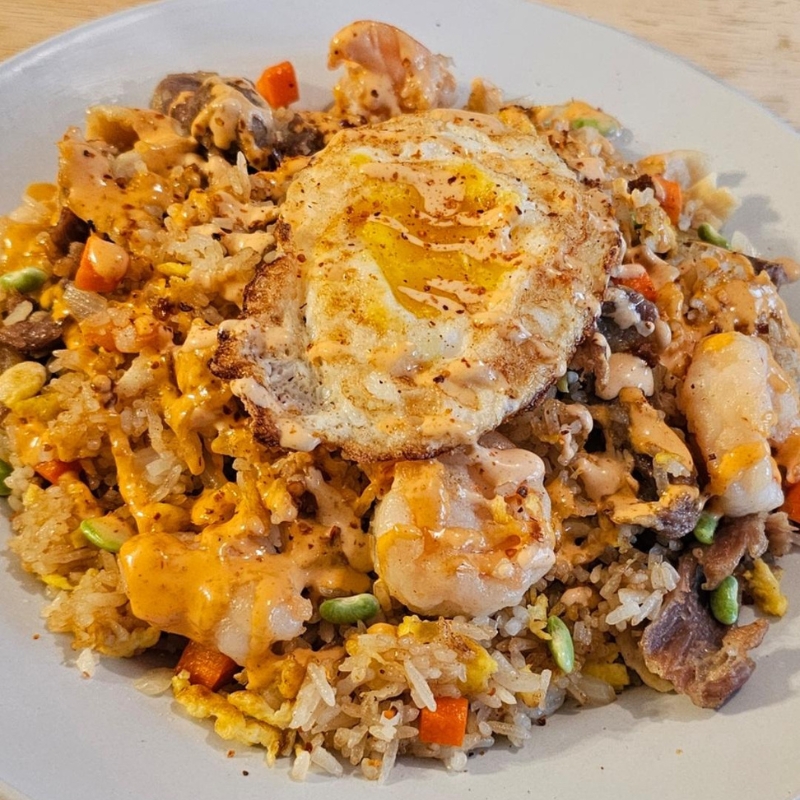 Seafood beef fried rice topped with sunny-side-up egg at Umami Sushi & Chinese Cuisine, an Asian Fusion Restaurant in Minneapolis