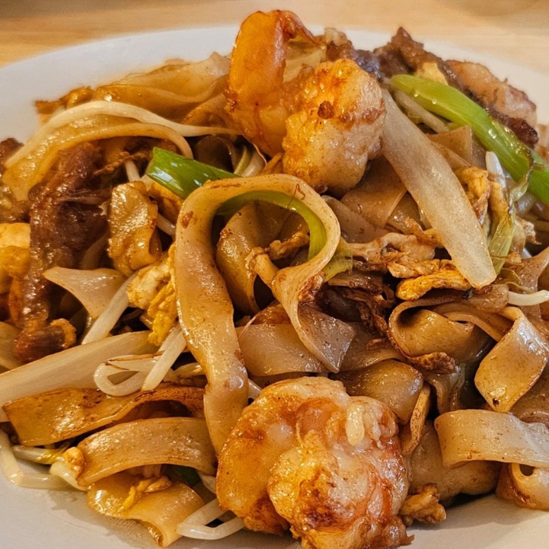 Wok-fried wide rice noodles with prawns, beef and bean sprouts at Umami Sushi & Chinese Cuisine, an Asian Fusion Restaurant in Minneapolis