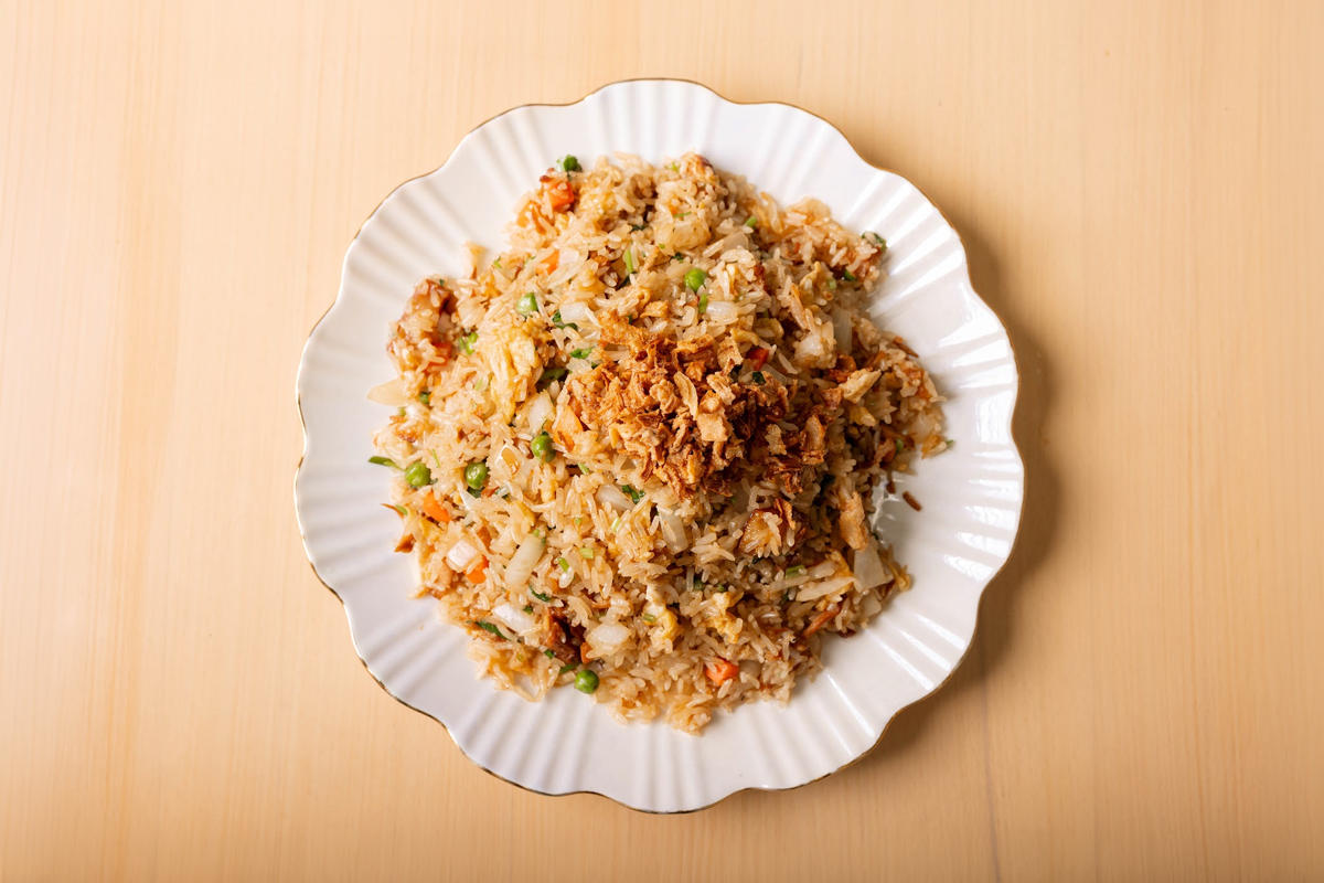 Savory house fried rice with peas, veggies, egg and crispy shallot topping at Umami Fusion, a Asian Restaurant in Miami Gardens
