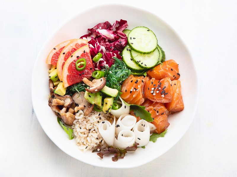 Vibrant poke bowl with salmon, citrus, avocado, and fresh veggies at Ume Poke, a Asian Fusion Restaurant in Jacksonville