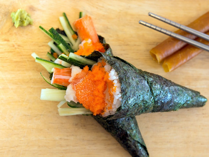 Crispy hand roll filled with crab, cucumber, and bright orange tobiko at Ume Poke, a Asian Fusion Restaurant in Jacksonville