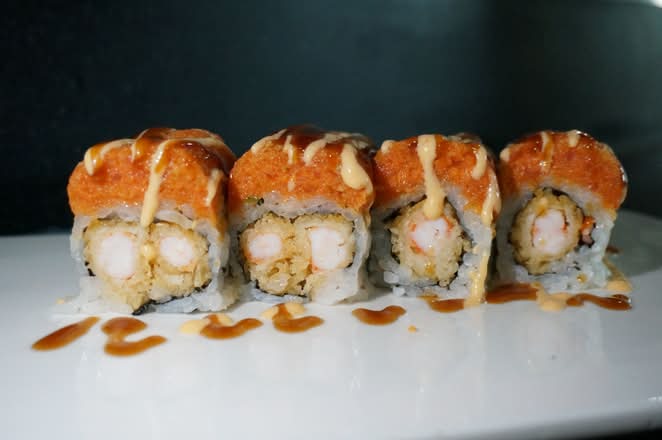 Roll with shrimp tempura, topped with sauce at Umi Japanese Cuisine, a Japanese Restaurant in Washington